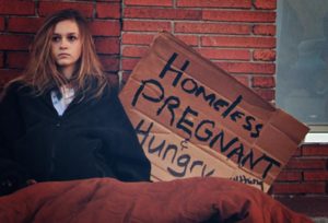 Homeless pregnant teen on the street begging for food